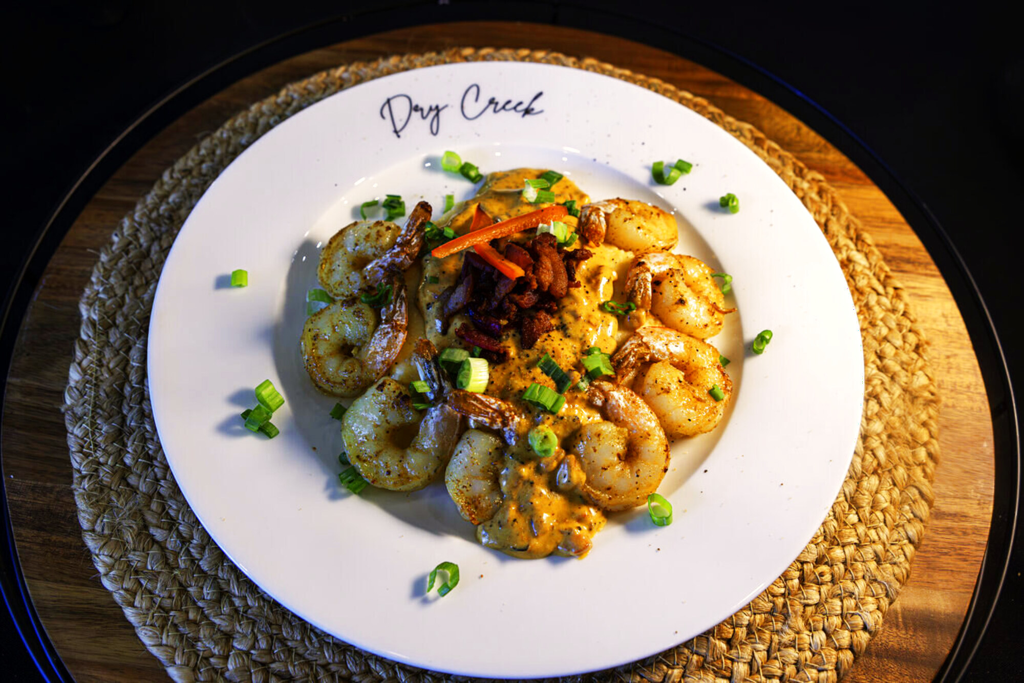 Shrimp and risotto plated on a white dish