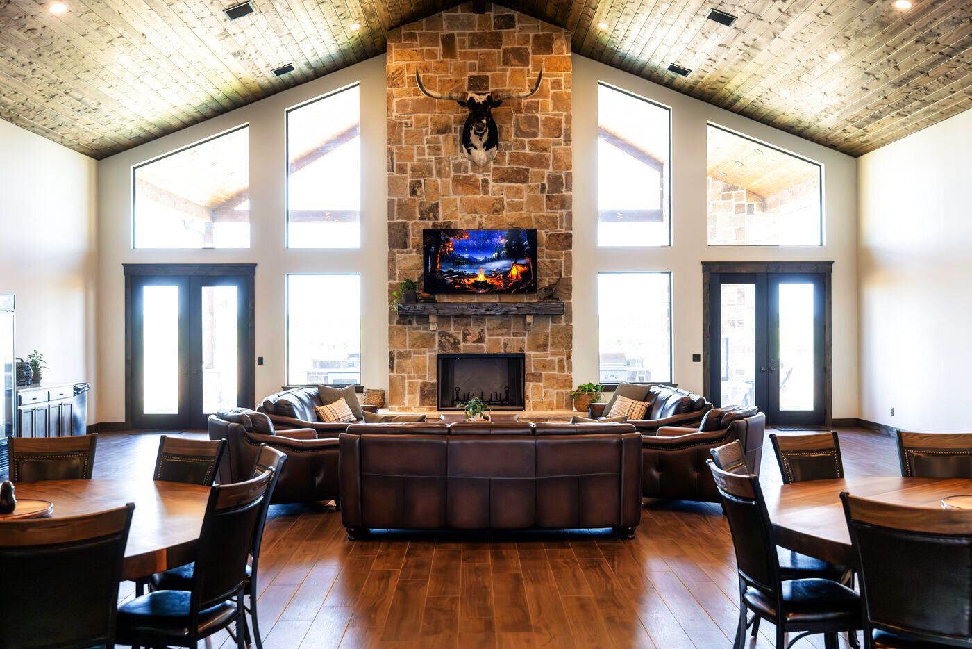 The great room with leather seating and stone fireplace