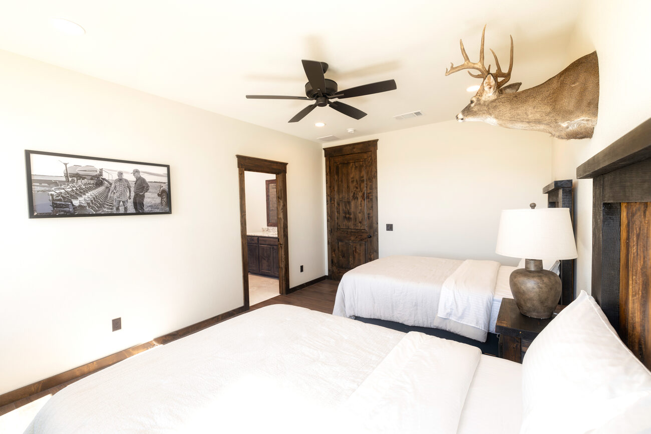 A bedroom with a single bed and framed art