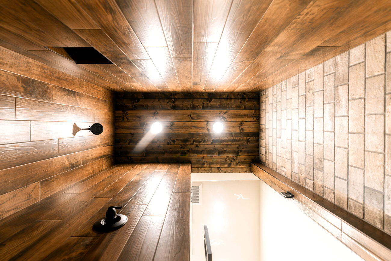 A bedroom with a dark wood bed and ceiling fan