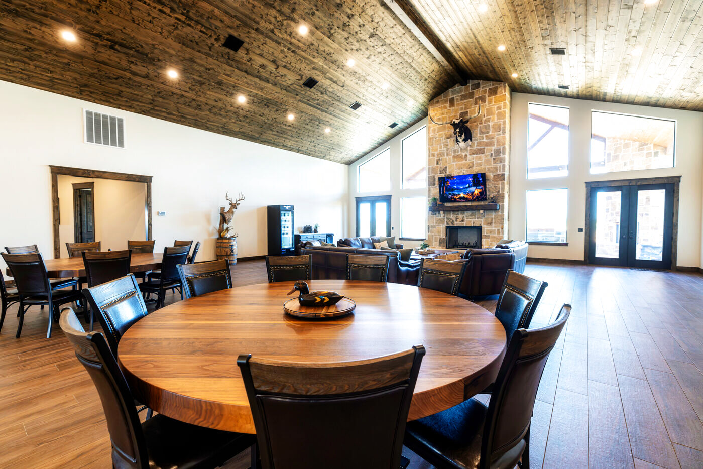 Round dining tables under timber ceilings