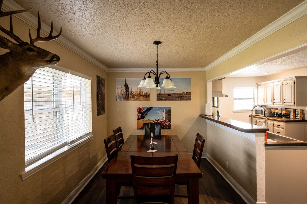 The dining table under an antler chandelier at Pecan Creek