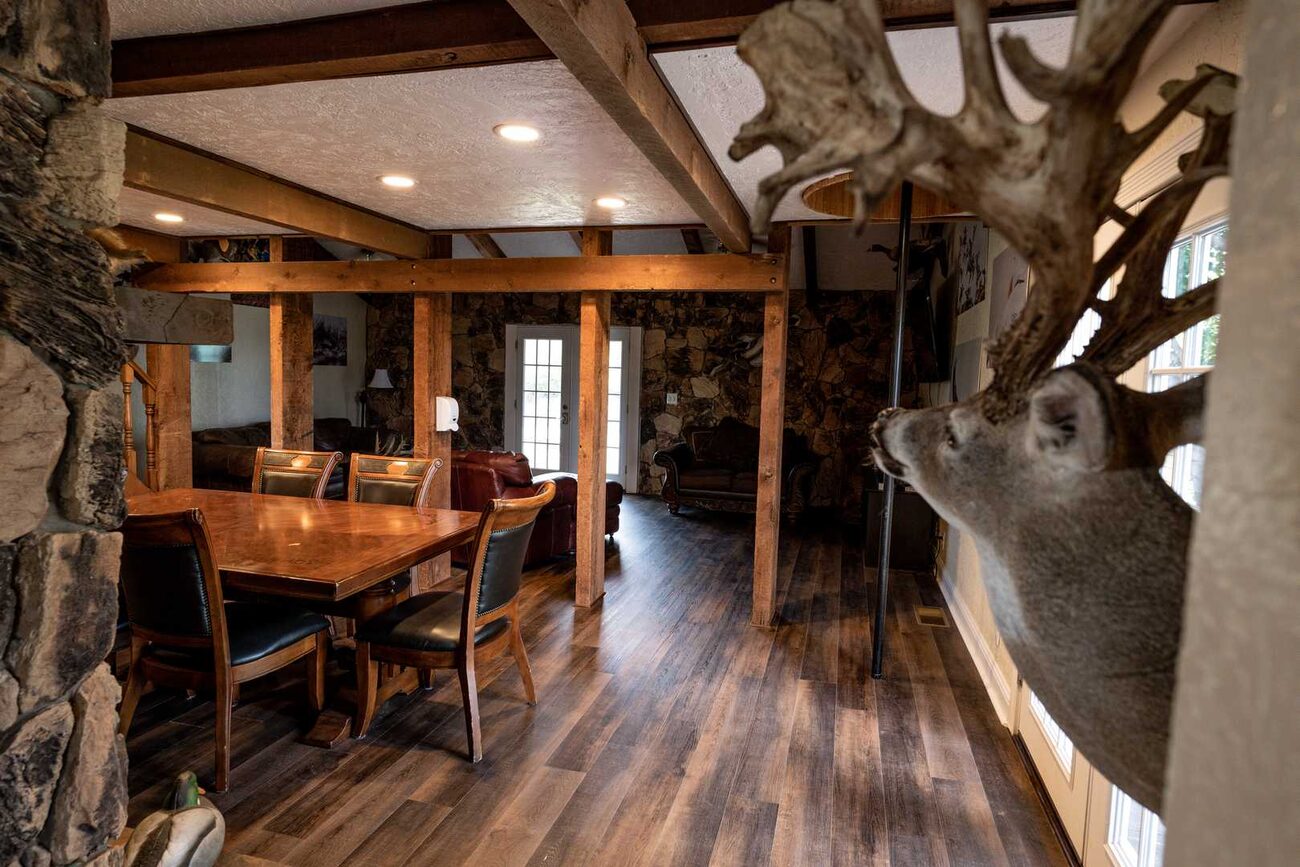 Open living and dining under wood beams at Pecan Creek