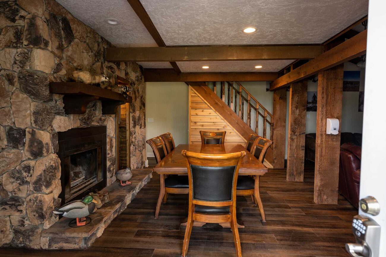 The great room with stone fireplace and leather seating at Pecan Creek