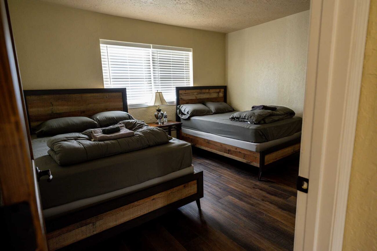 A bright bedroom with two beds at Pecan Creek